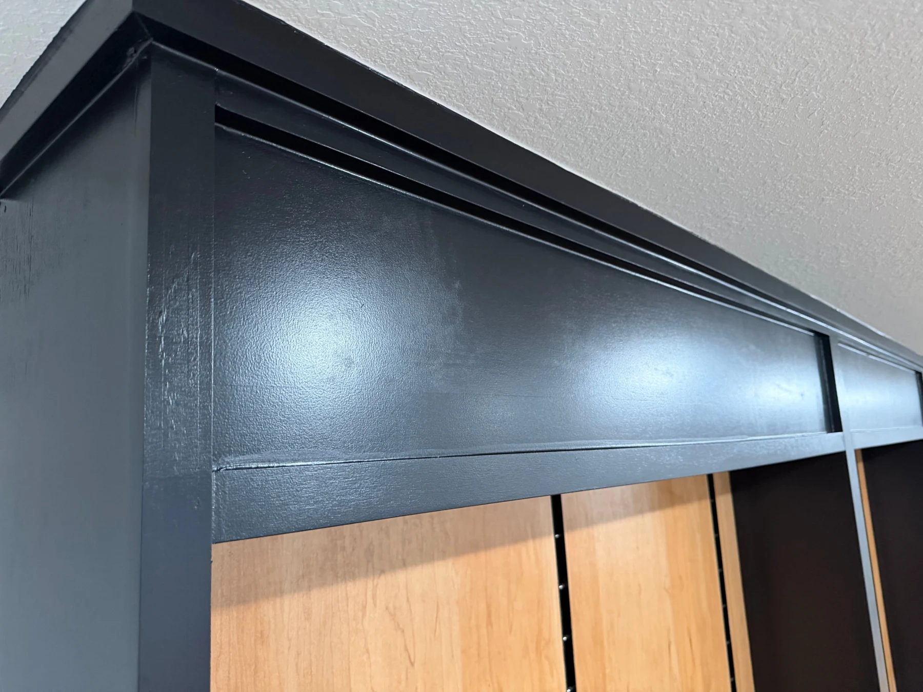 Close-up of the black painted header with its stepped reveal and framed edge